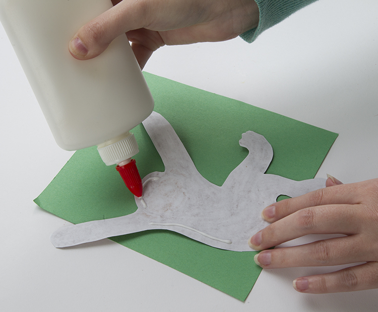 Gluing monkey to green paper